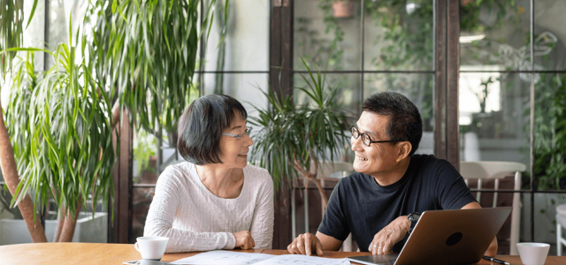 a couple speaking at a dinner table